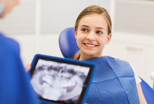 Young girl smiling in dental chair