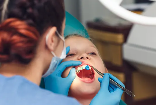 Patient receiving dental sealants