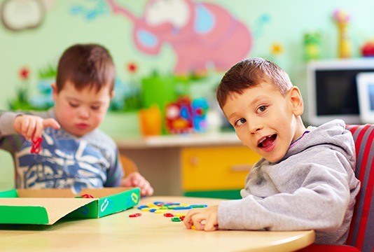 Two young kids at school table