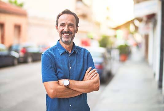 Man smiling after handling a dental emergency in Raleigh