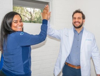dentist high fiving team member in Raleigh
