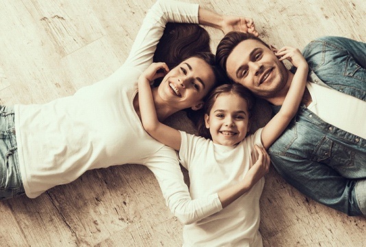 smiling couple with young child