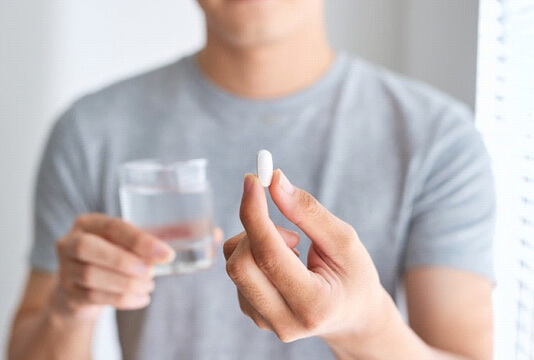 a man taking an oral conscious sedation pill