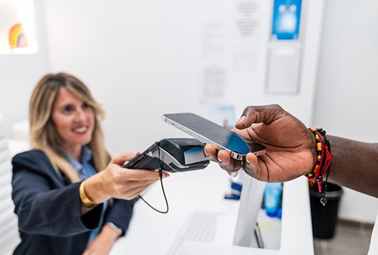 Person paying for treatment with phone