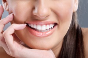 Woman smiling with her chin in her hand