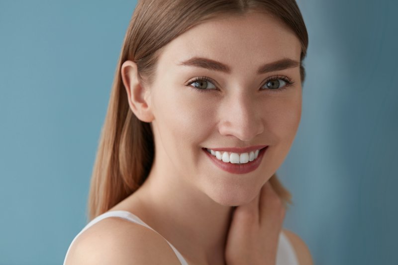 woman smiling with porcelain veneers in Raleigh
