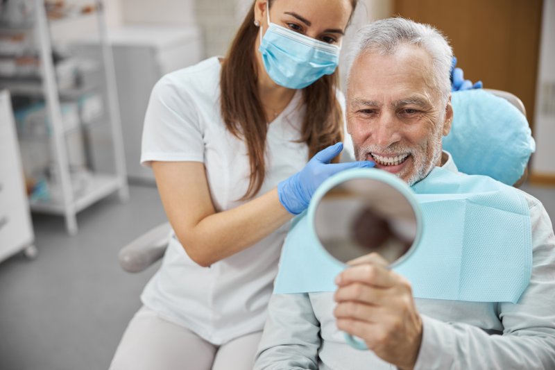 An older man happy with his implant treatment