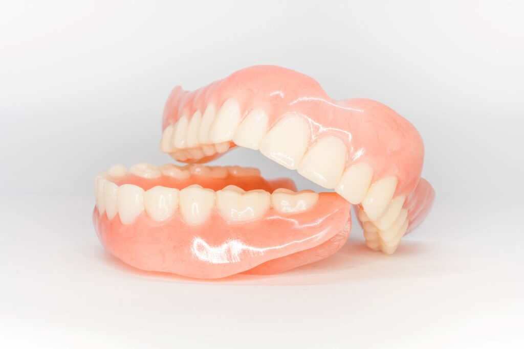 Full set of dentures on white background