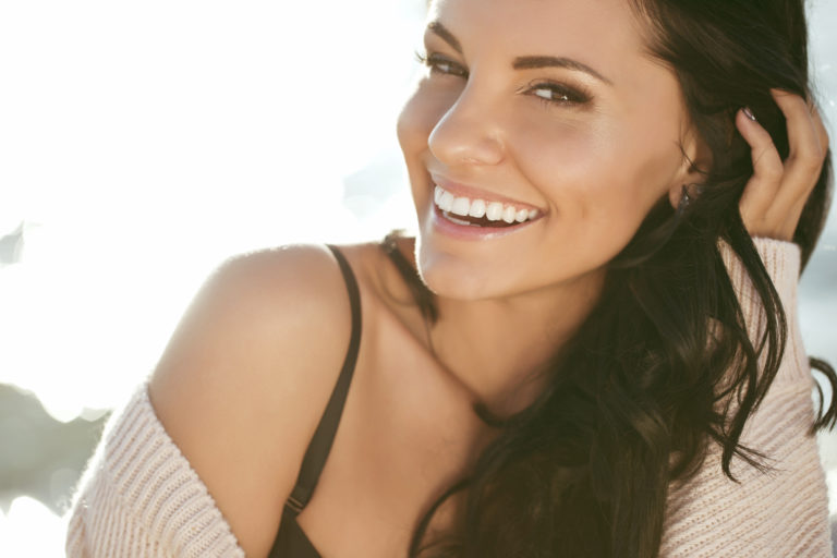 Woman showing off her straight, white smile