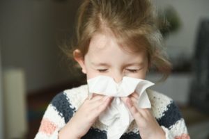girl blowing her nose 