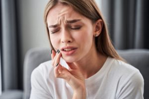 A woman experiencing facial pain