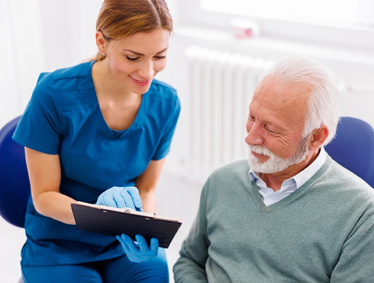 Dentist and patient reviewing images on computer